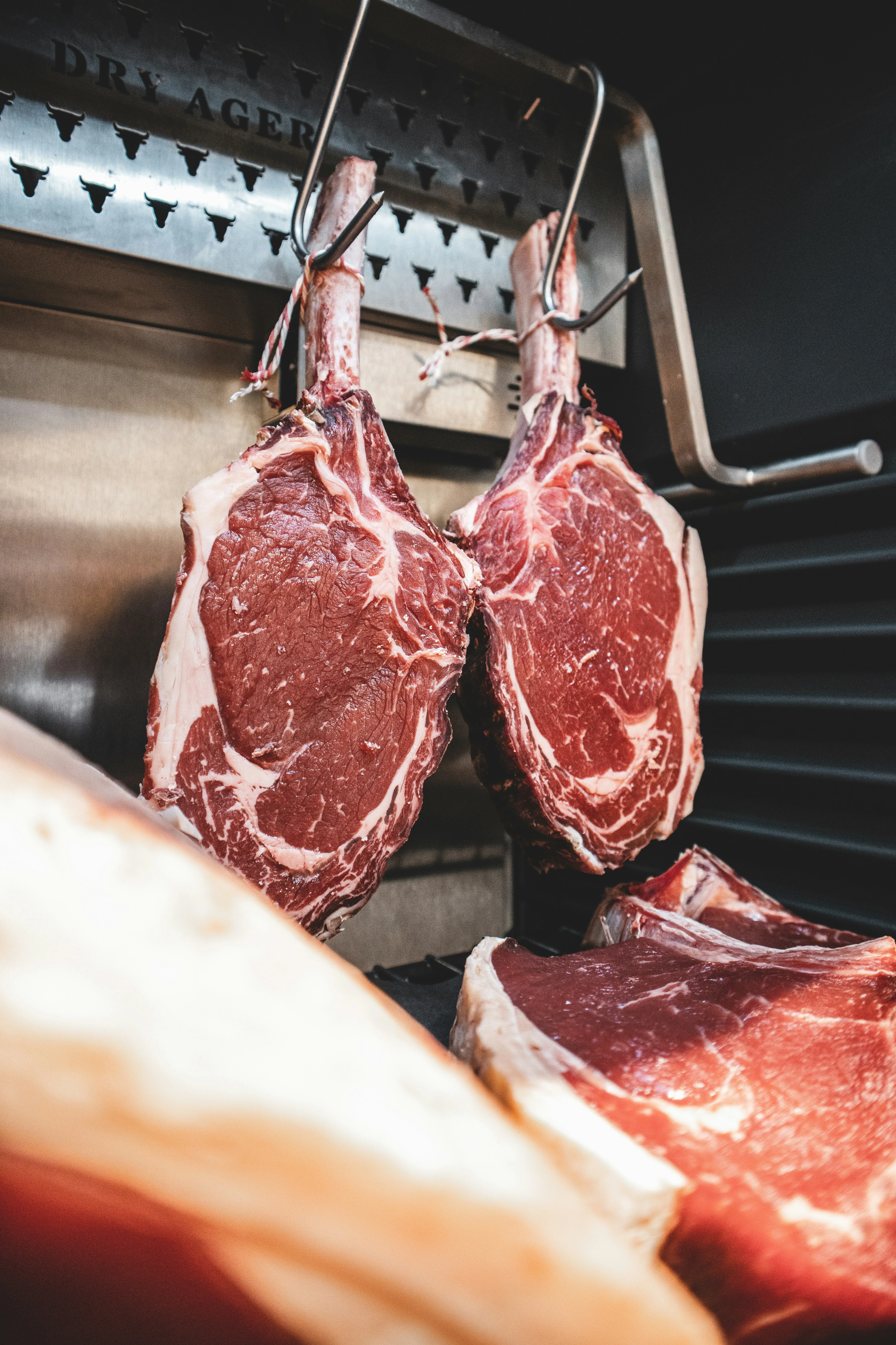 Cuts of dry-aged beef — the kind of quality bulk meat hosts organize through DiceShare